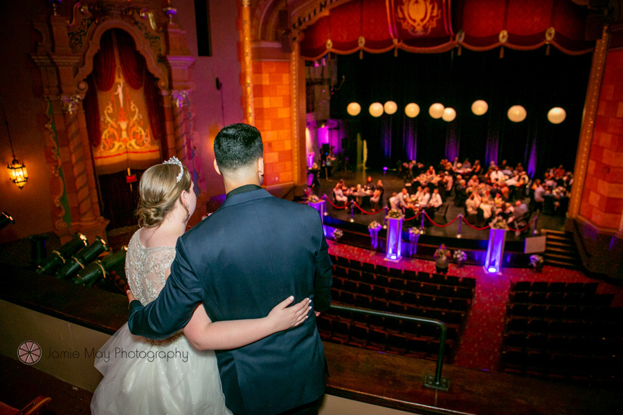 Bride and groom overlooking reception