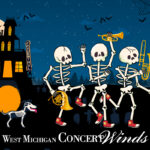 Skeletons holding wind instruments outside of haunted house